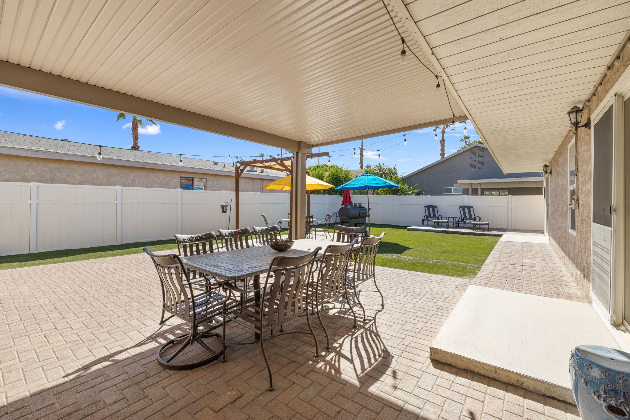 47800 Madison Street, Unit 79 Indio, CA 92201 - Photo 10 of 31 a view of a patio with table and chairs under an umbrella