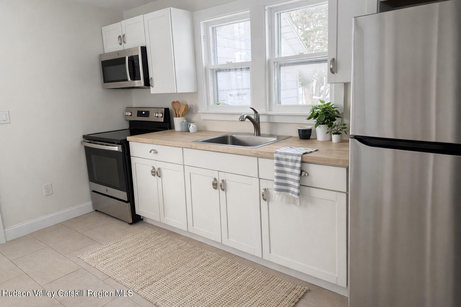 222 Zandhoek Road Hurley, NY 12443 - Photo 7 of 23 a kitchen with stainless steel appliances a refrigerator sink and white cabinets