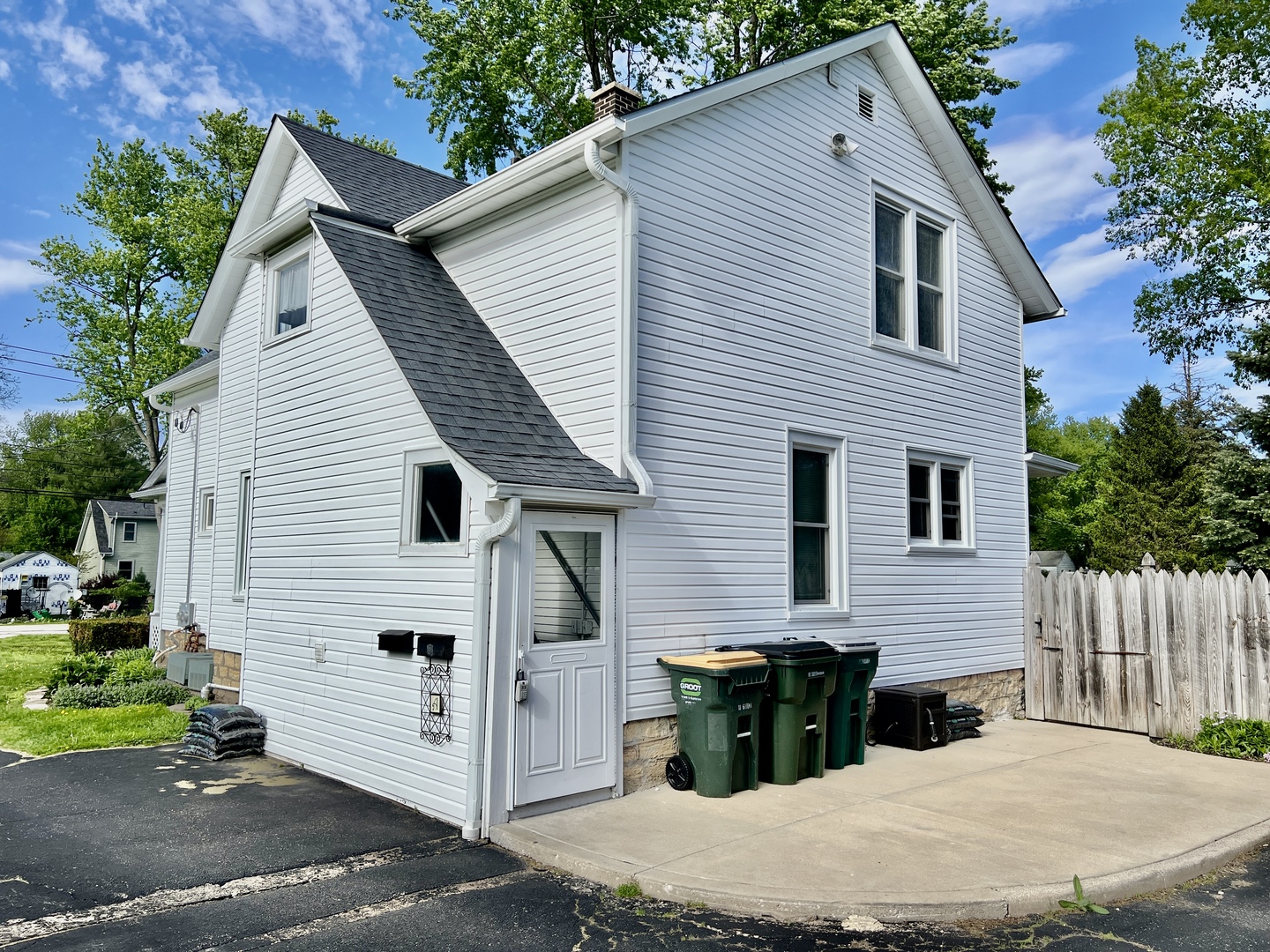 830 Garfield Avenue, Unit UP Batavia, IL 60510 - Photo 2 of 12 a view of a white house with a small yard and a large tree