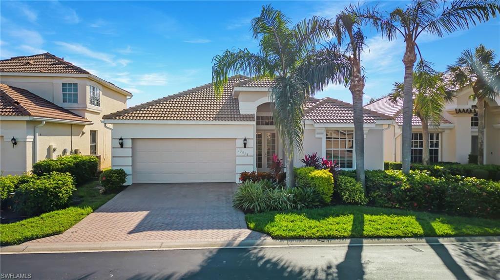 17818 Modena Road Miromar Lakes, FL 33913 - Photo 1 of 21 a front view of a house with a garden
