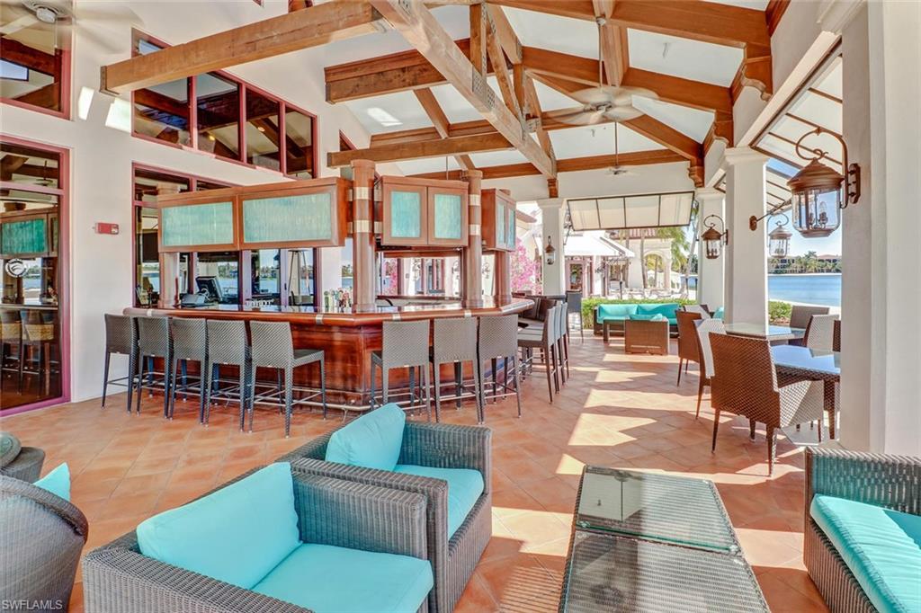 17818 Modena Road Miromar Lakes, FL 33913 - Photo 15 of 21 a view of a patio with couches chairs and potted plants
