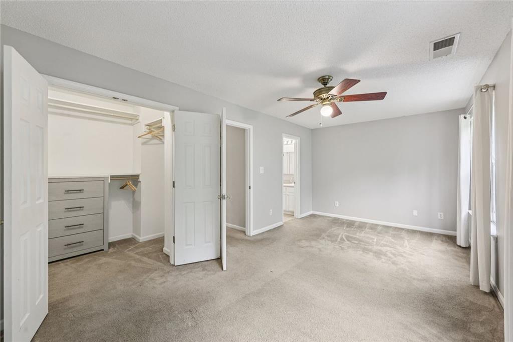 6812 Gallant Circle Southeast, Unit 1 Mableton, GA 30126 - Photo 11 of 24 a view of an empty room with a ceiling fan