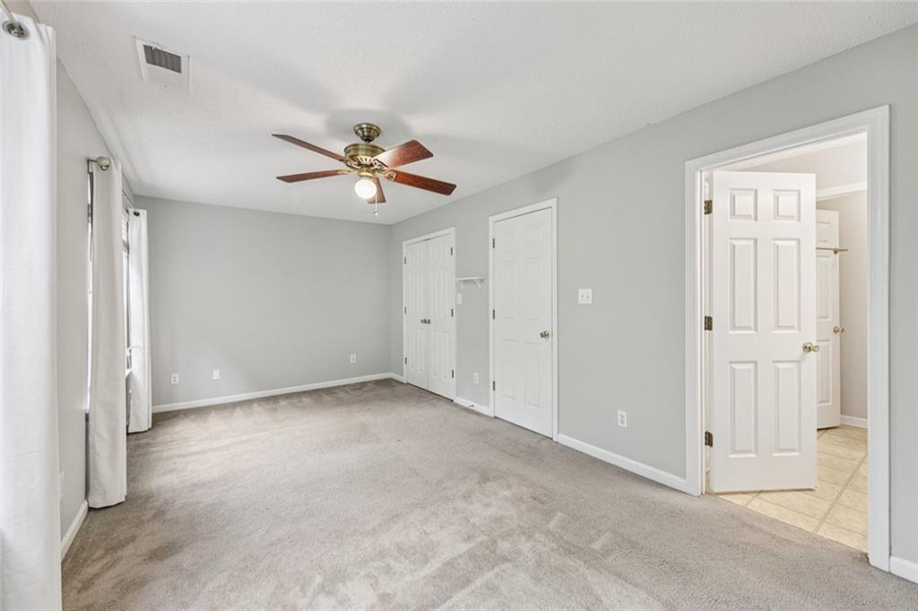 6812 Gallant Circle Southeast, Unit 1 Mableton, GA 30126 - Photo 13 of 24 a view of an empty room with a ceiling fan