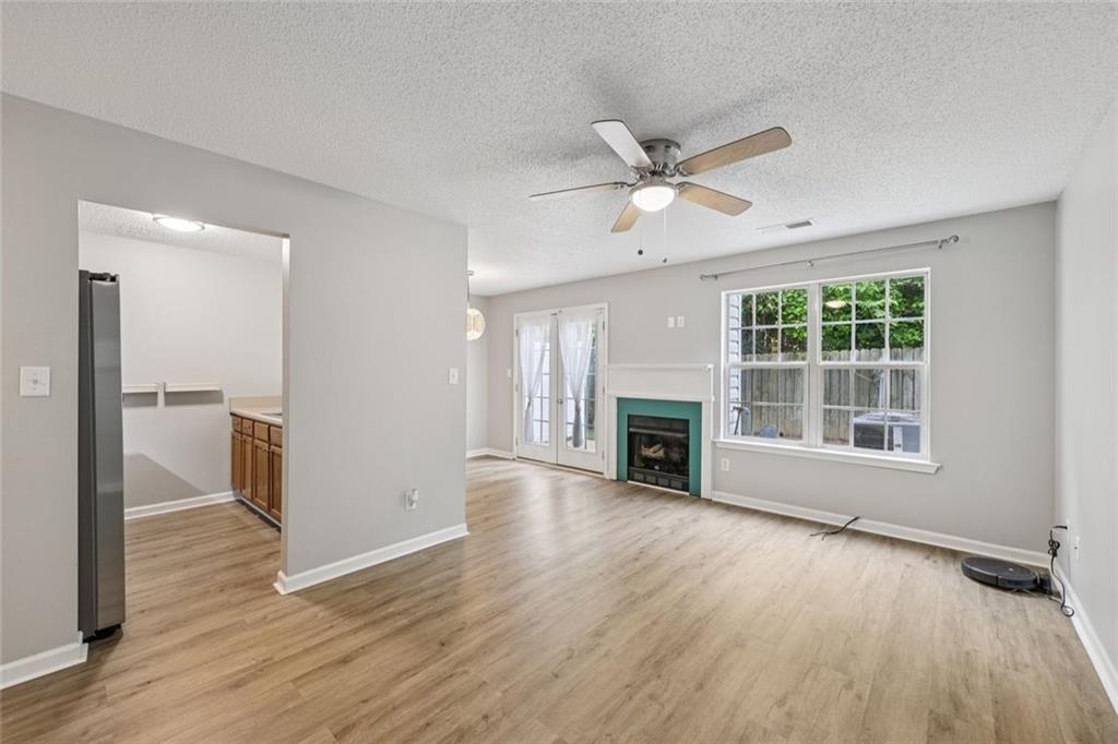 6812 Gallant Circle Southeast, Unit 1 Mableton, GA 30126 - Photo 2 of 24 wooden floor in an empty room with a fireplace