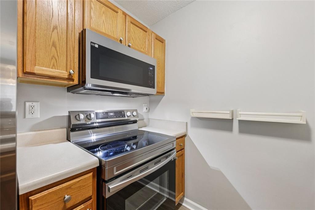 6812 Gallant Circle Southeast, Unit 1 Mableton, GA 30126 - Photo 8 of 24 a stove top oven sitting inside of a kitchen