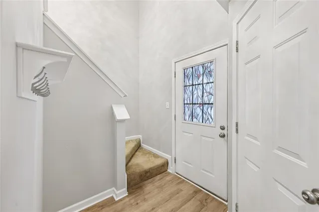 a view of an entryway with wooden floor
