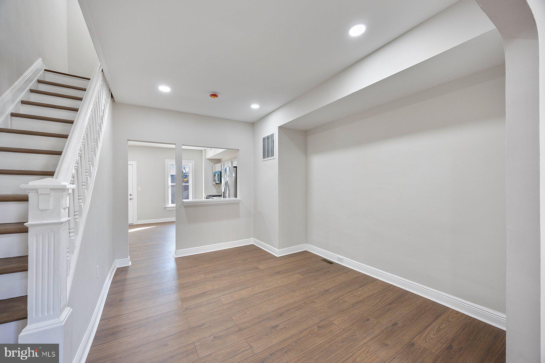 117 Collins Avenue Baltimore, MD 21229 - Photo 6 of 27 a view of empty room with wooden floor