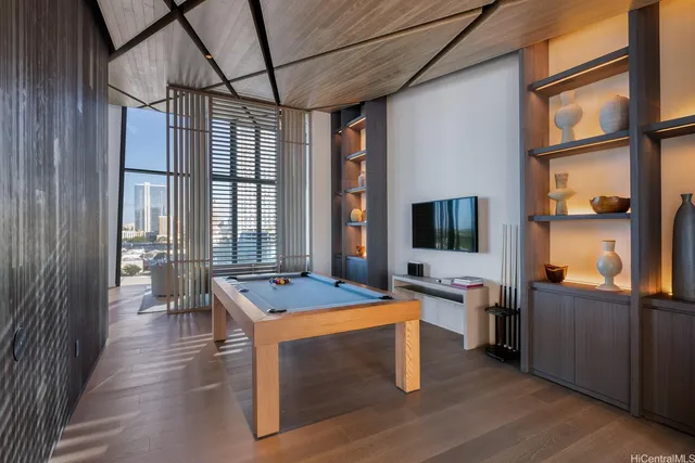 a dining hall with stainless steel appliances granite countertop a stove and a refrigerator