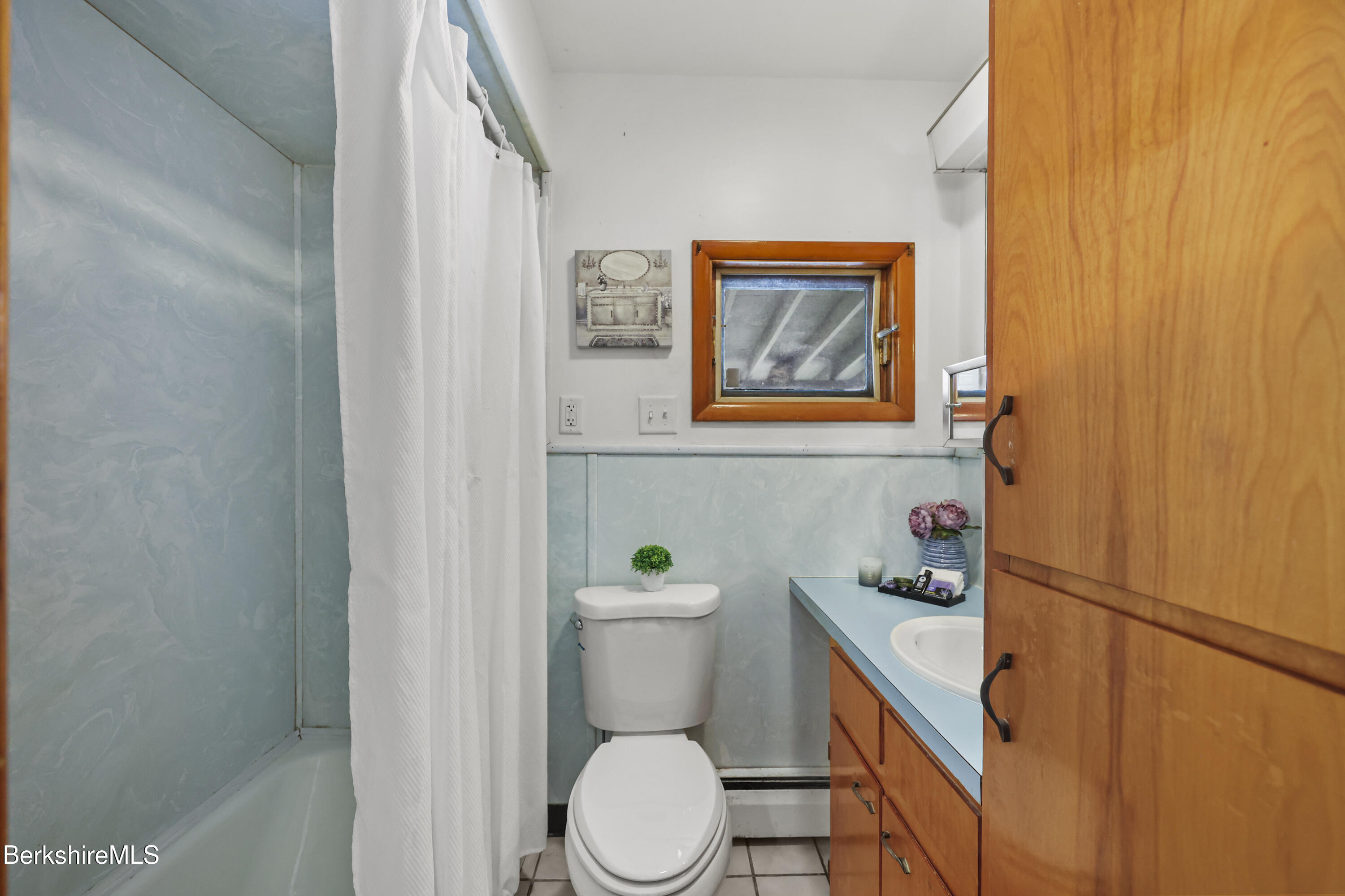 20 Crystal Street Pittsfield, MA 01201 - Photo 24 of 29 a white toilet sitting next to a bathroom sink and vanity