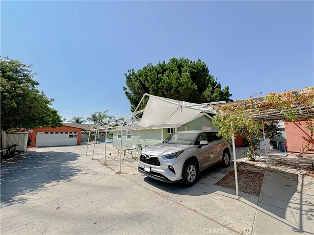 a view of a house with a cars park next to a road