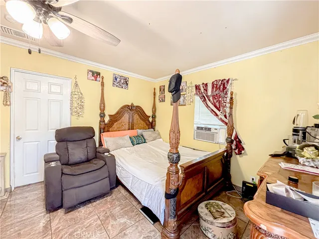 a bedroom with furniture and a large window