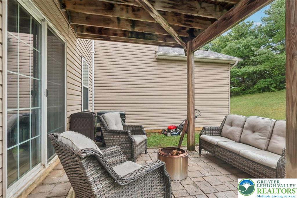 5192 Spring Ridge Drive East Macungie, PA 18062 - Photo 8 of 11 a view of a patio with couches chairs and a potted plant