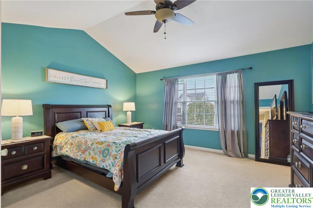 5192 Spring Ridge Drive East Macungie, PA 18062 - Photo 10 of 11 a bedroom with a bed and a chandelier