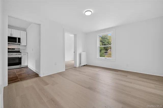 an empty room with windows and closet