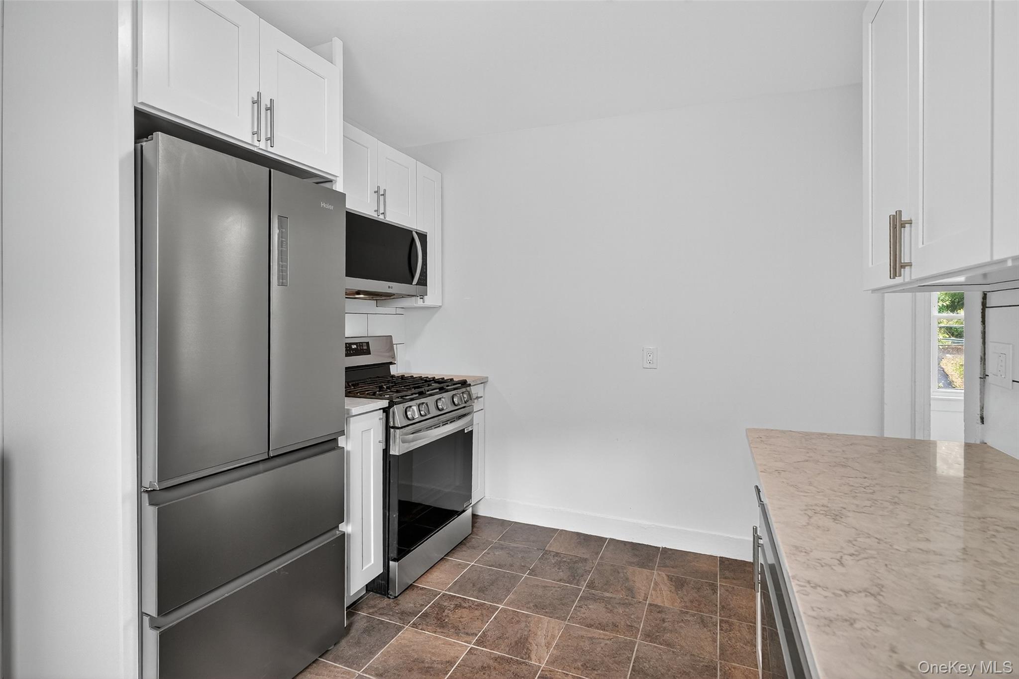 23 Ann Street, Unit 2 Ossining, NY 10562 - Photo 18 of 23 a kitchen with granite countertop a refrigerator and a stove