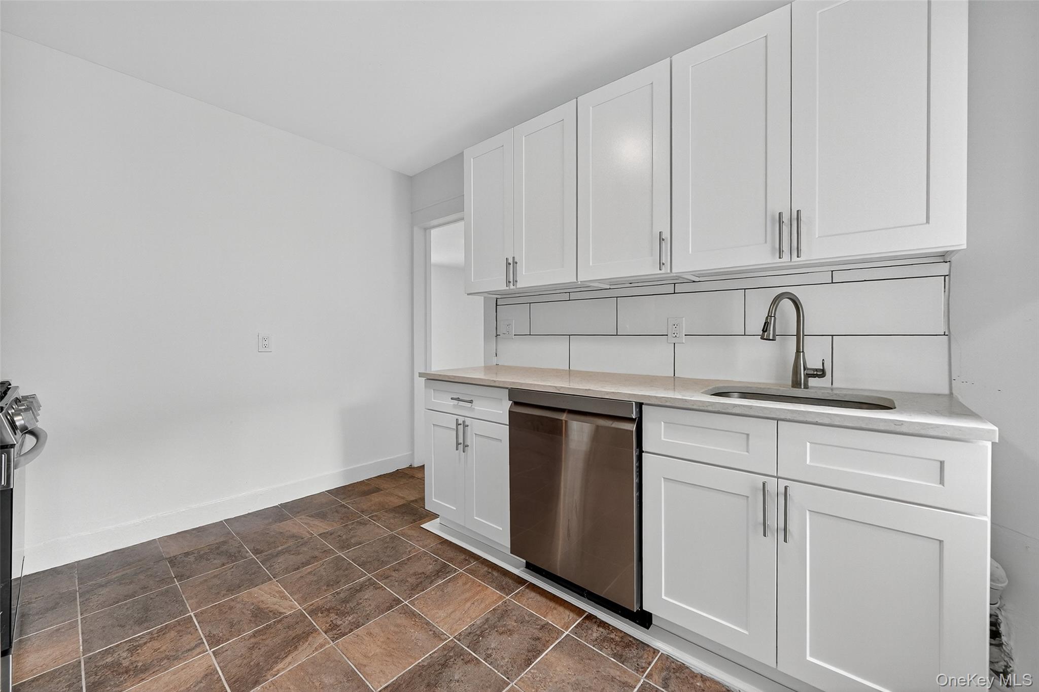 23 Ann Street, Unit 2 Ossining, NY 10562 - Photo 20 of 23 a kitchen with white cabinets and sink