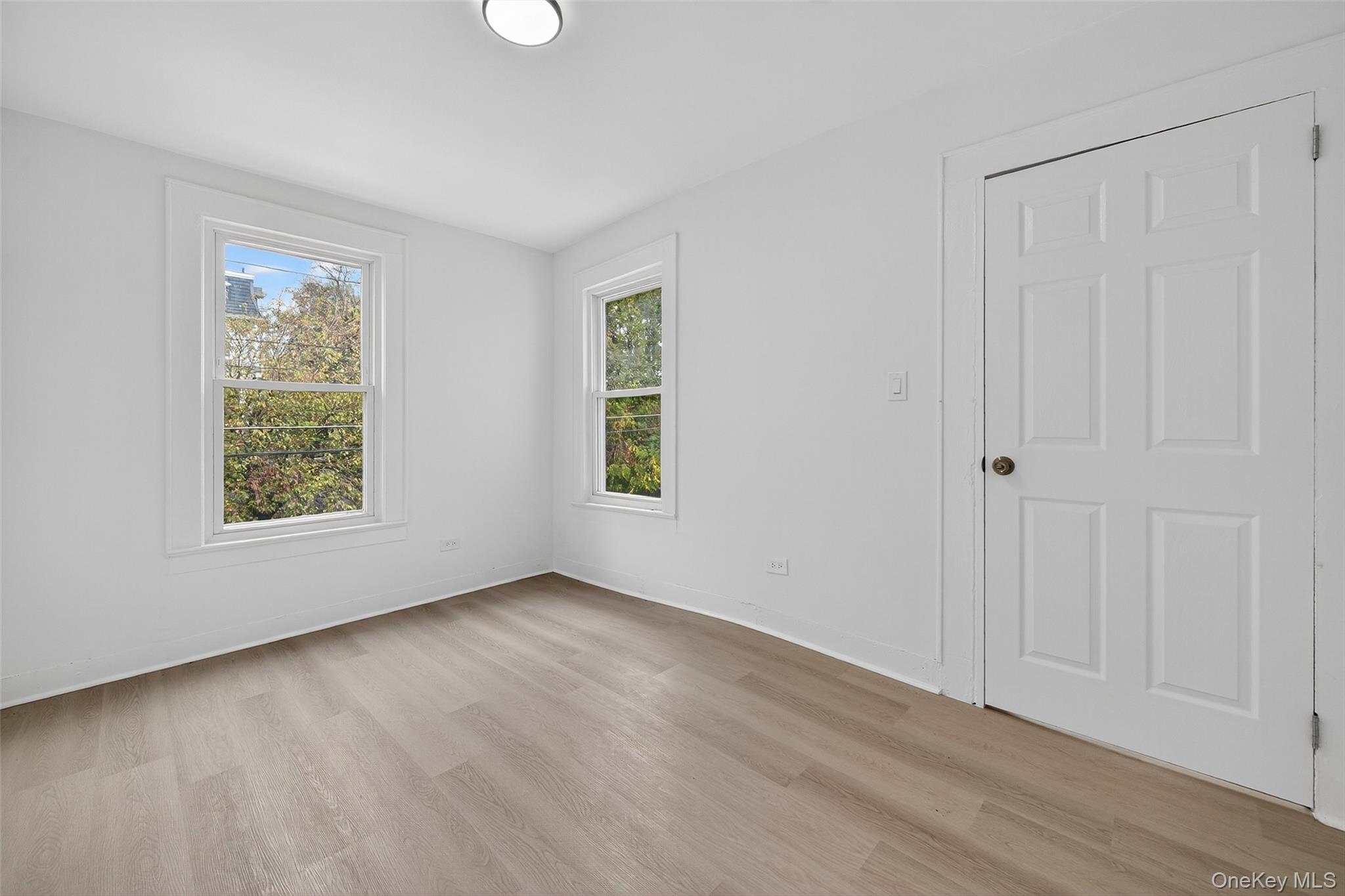 23 Ann Street, Unit 2 Ossining, NY 10562 - Photo 23 of 23 an empty room with wooden floor and windows