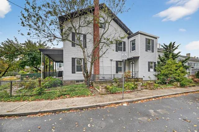 a front view of a house with a yard and a garage