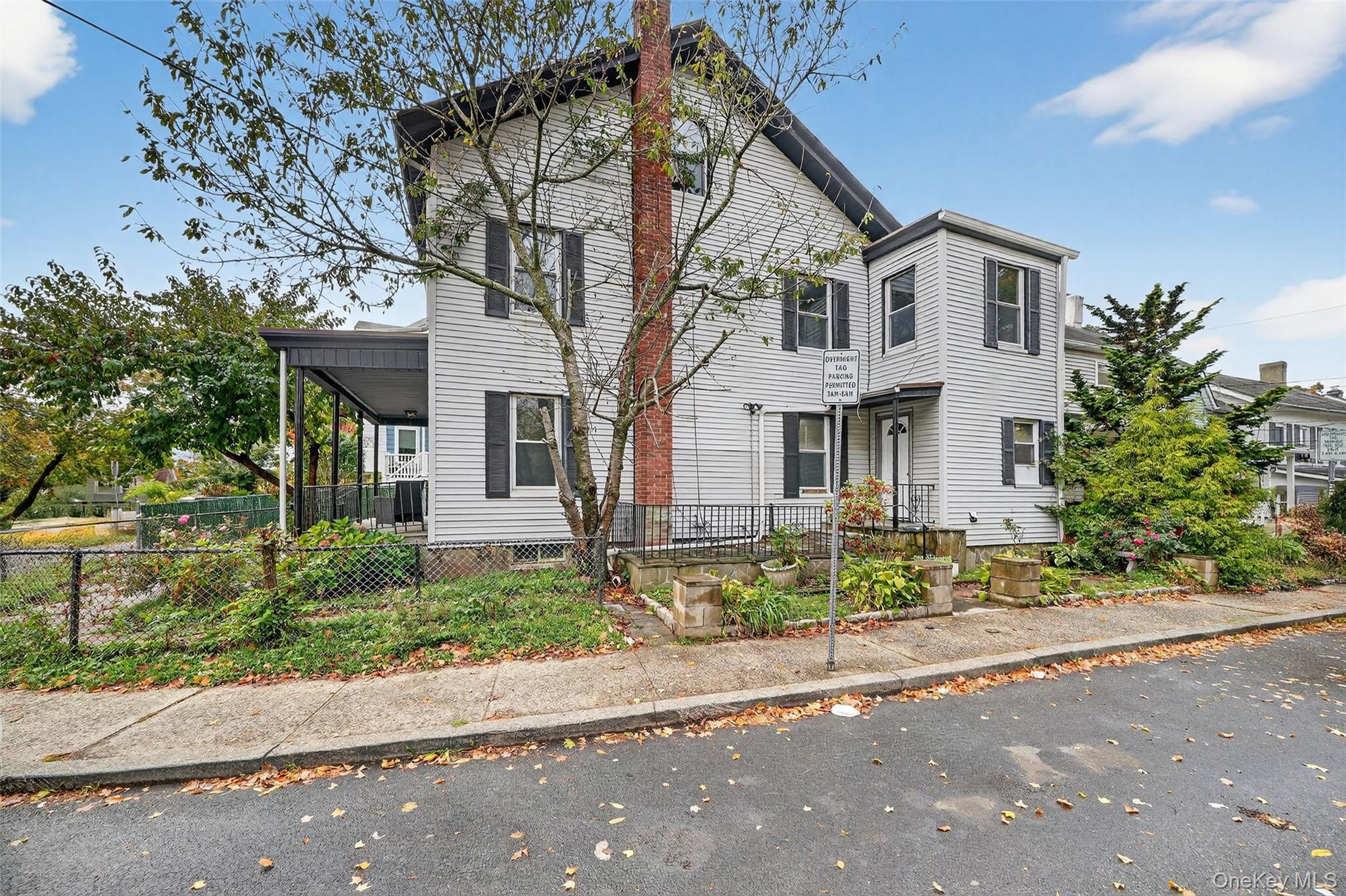 23 Ann Street, Unit 2 Ossining, NY 10562 - Photo 6 of 23 a front view of a house with a yard and a garage