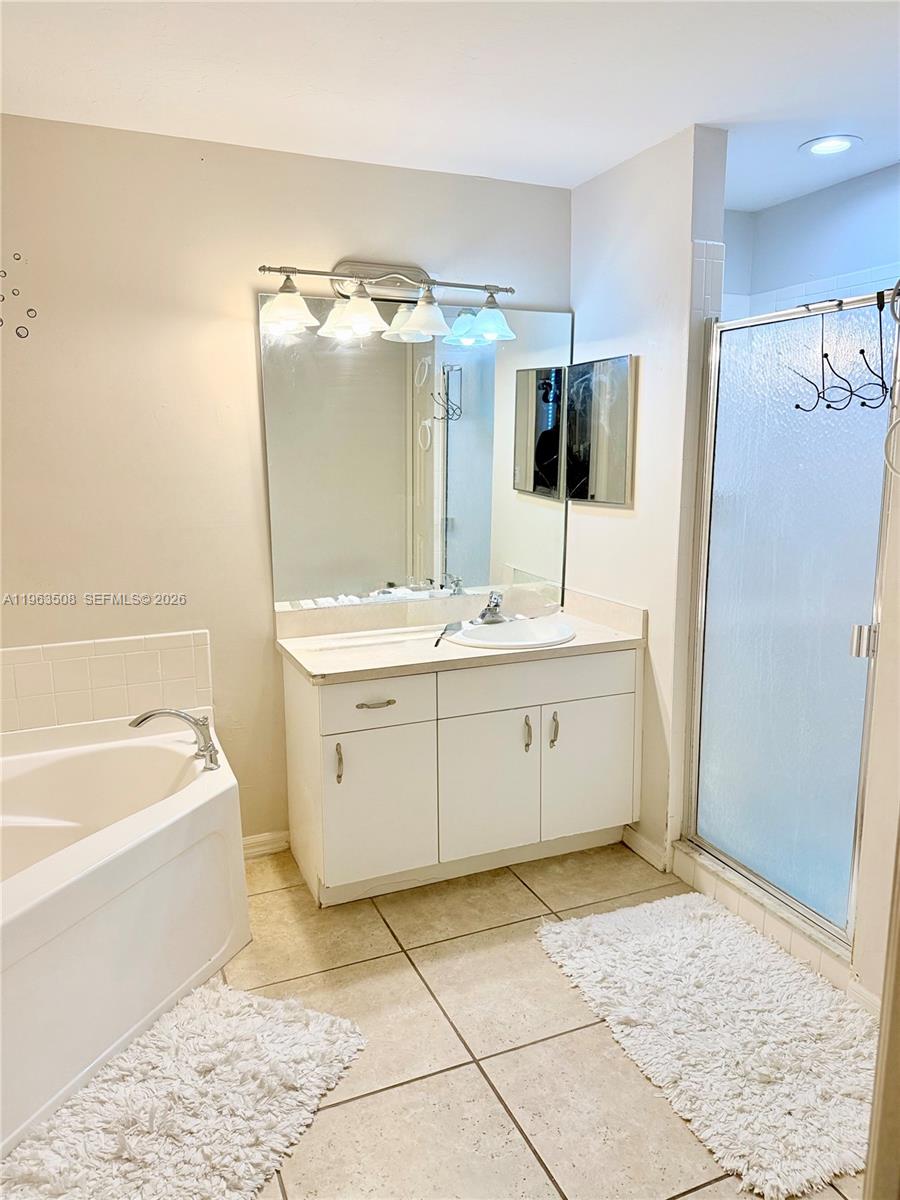 126 Zenith Circle Fort Myers, FL 33913 - Photo 11 of 24 a bathroom with a double vanity sink mirror and bathtub
