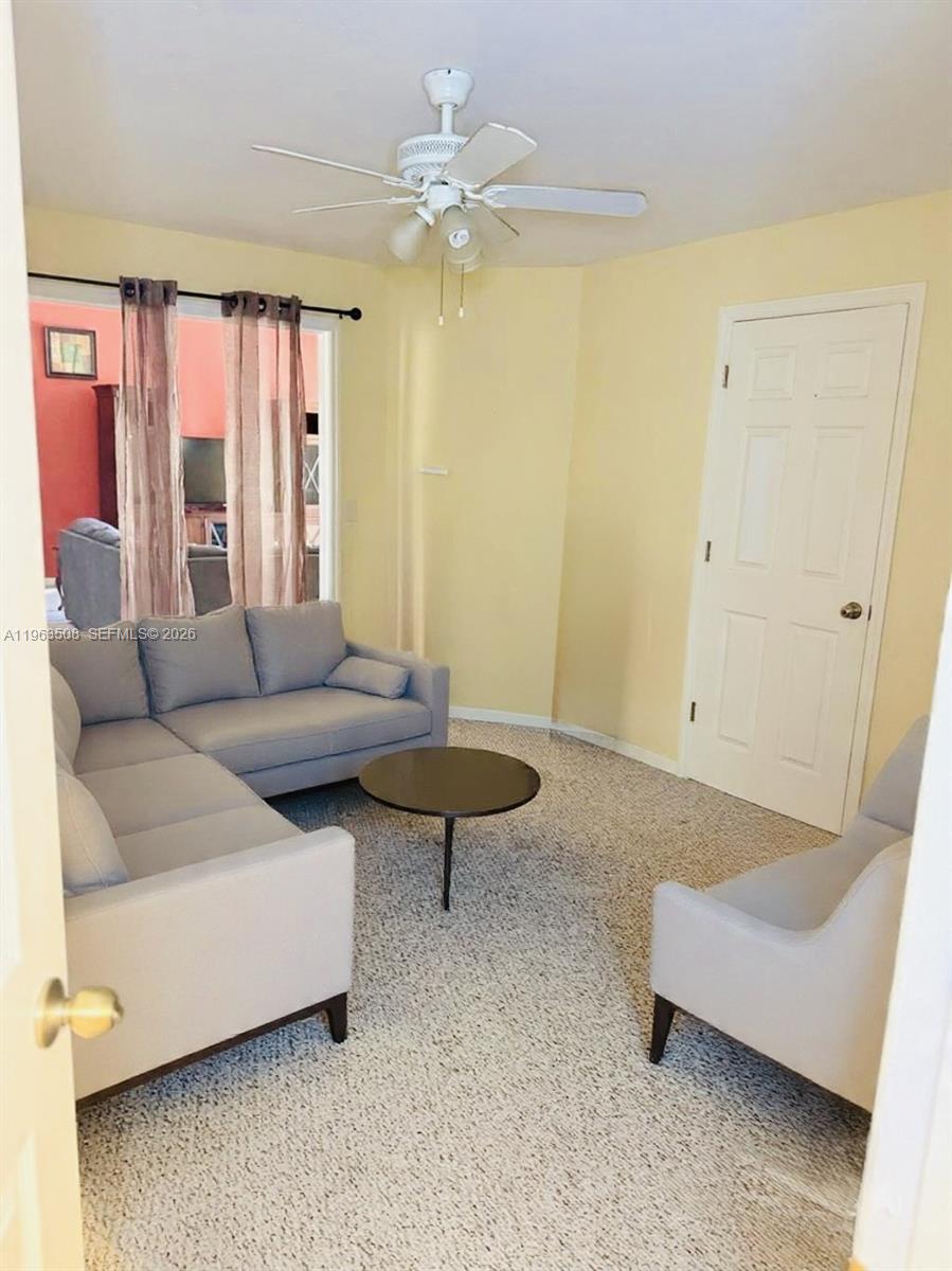 126 Zenith Circle Fort Myers, FL 33913 - Photo 19 of 24 a living room with furniture and a chandelier