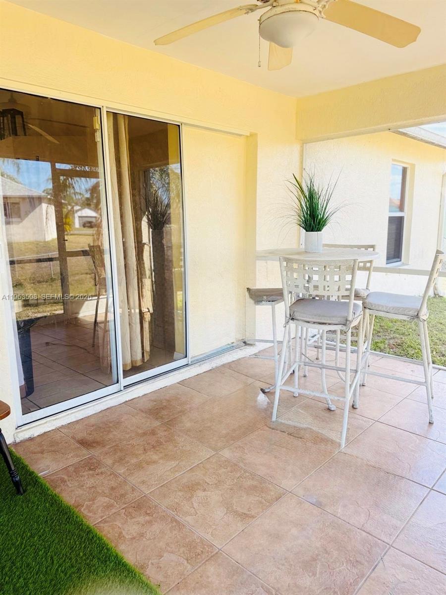 126 Zenith Circle Fort Myers, FL 33913 - Photo 21 of 24 a patio with a table and chairs and potted plants