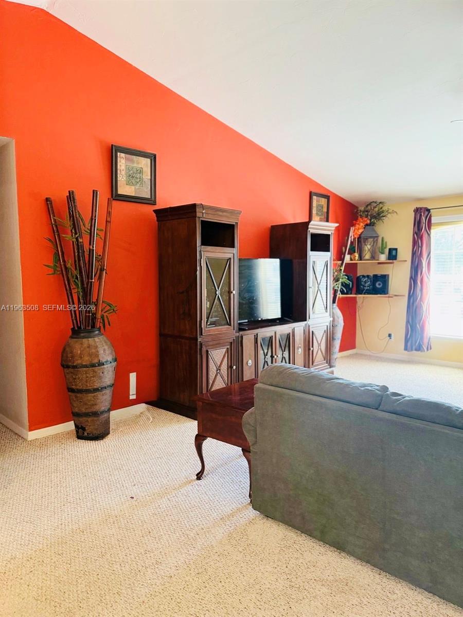 126 Zenith Circle Fort Myers, FL 33913 - Photo 4 of 24 a living room with furniture and a flat screen tv