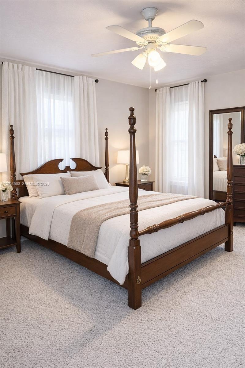 126 Zenith Circle Fort Myers, FL 33913 - Photo 10 of 24 a bedroom with a bed and a chandelier