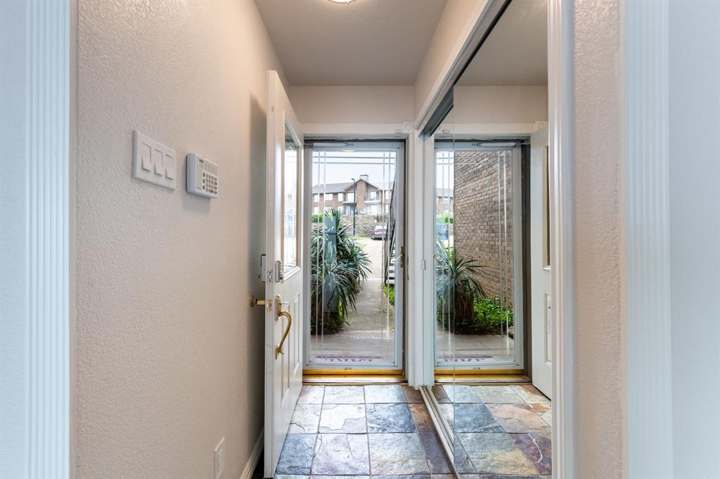 4610 Chaha Road, Unit 106 Garland, TX 75043 - Photo 6 of 25 a view of a hallway with a glass door