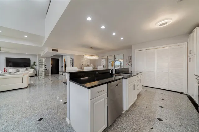 a kitchen with a stove and white cabinets
