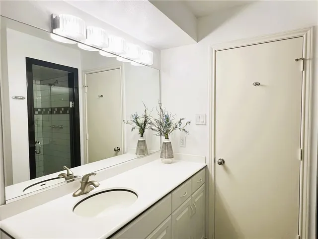 a large white bedroom with a bed and a couch