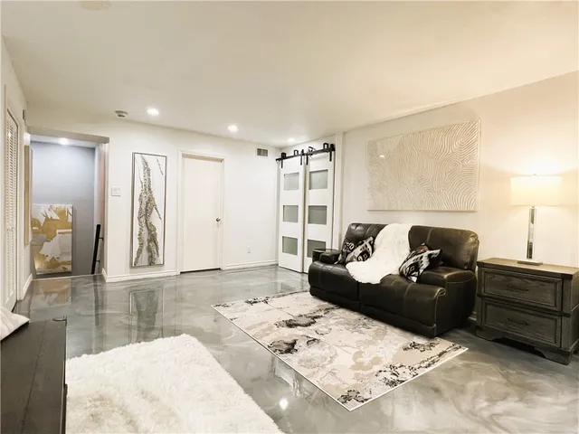 a bedroom with a bed and a view of kitchen