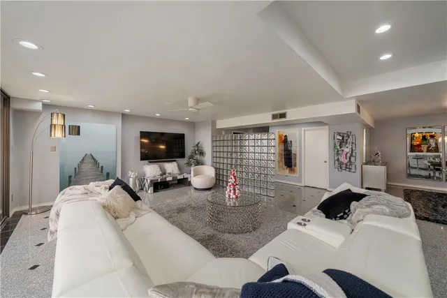 a living room with furniture a window and gym equipment