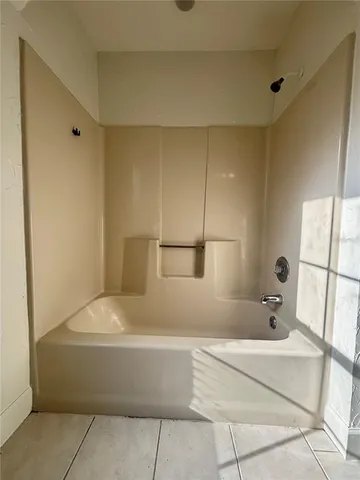 a bathroom with a bathtub and shower