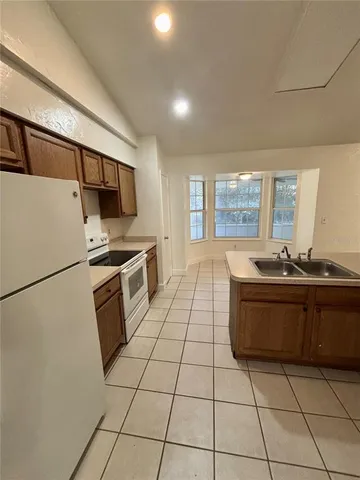 a kitchen with stainless steel appliances a refrigerator sink and cabinets
