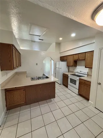 a large kitchen with a large counter top and stainless steel appliances