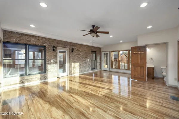 a view of an entryway with wooden floor