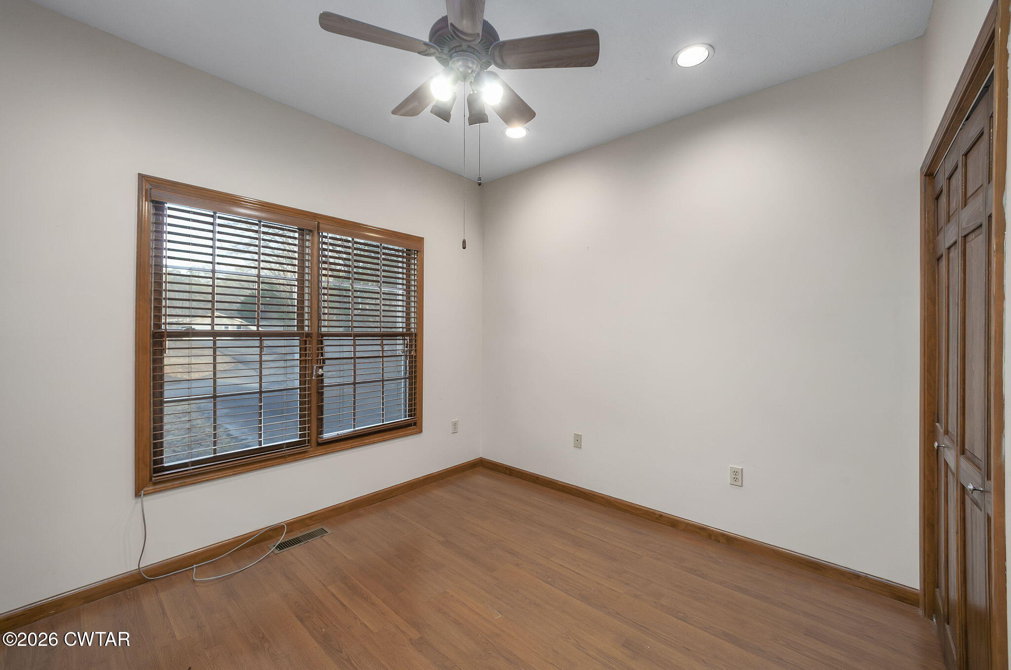 40 Pine Cove Parsons, TN 38363 - Photo 25 of 56 a view of an empty room with a window and wooden floor