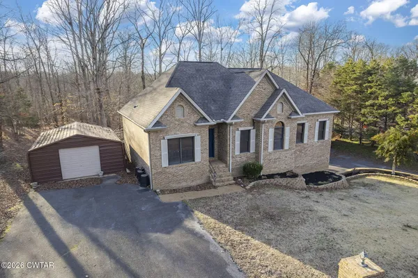 an aerial view of a house with a yard