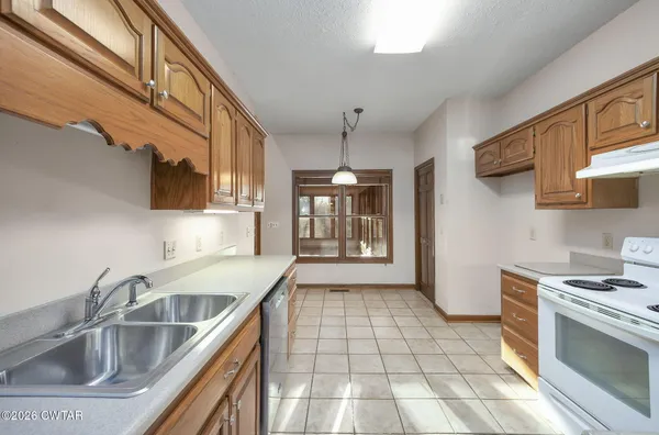 a kitchen with a sink cabinets and window