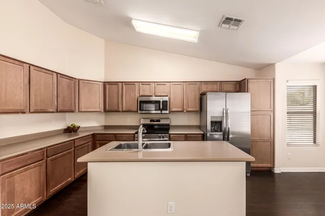 a kitchen with a sink a stove and refrigerator