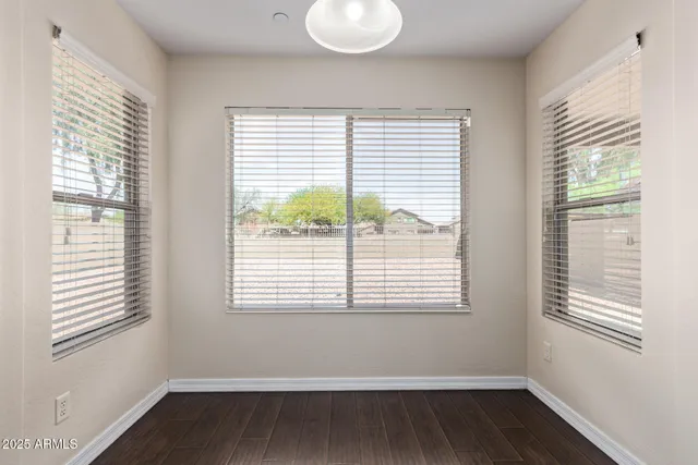 an open kitchen with granite countertop a sink and cabinets with wooden floor
