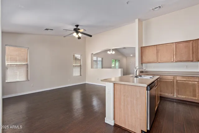 a view of kitchen with stainless steel appliances refrigerator stove microwave and cabinets