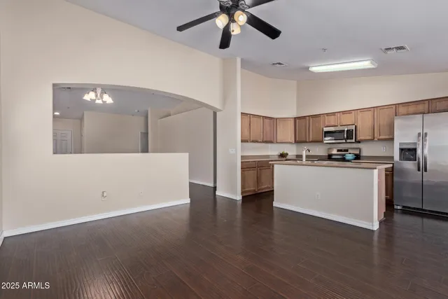 a kitchen with stainless steel appliances granite countertop a sink stove and cabinets