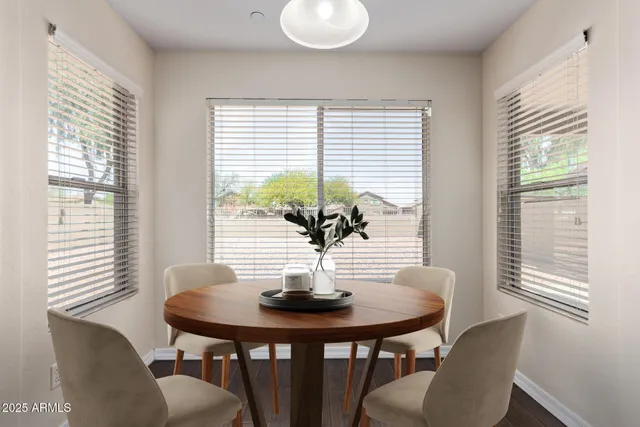 a view of a dining room with furniture and wooden floor