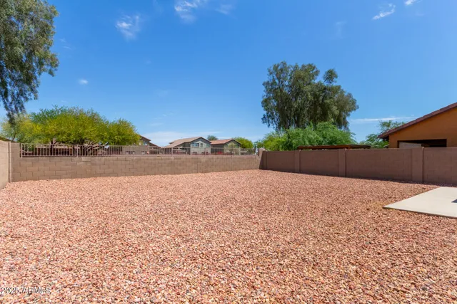 a view of a backyard with large trees