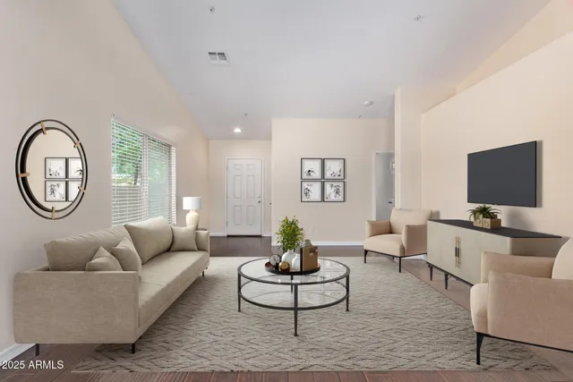 a living room with furniture a rug and a window