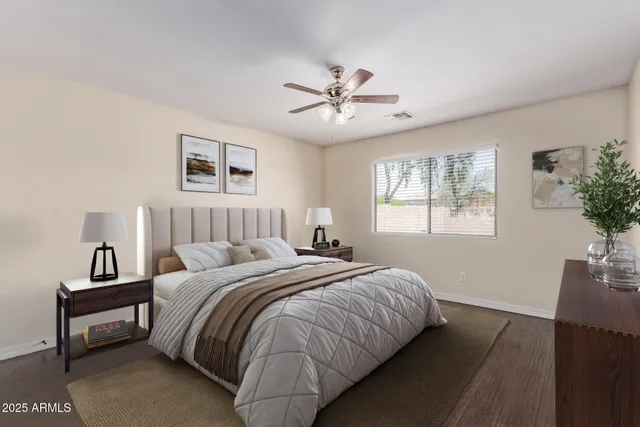 a bedroom with bed and a potted plant