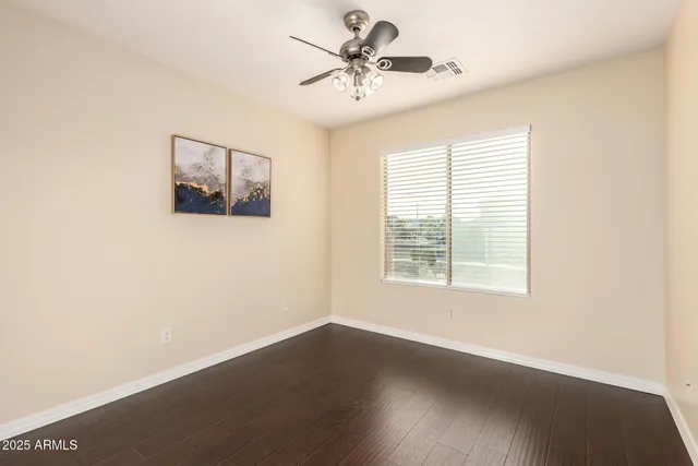 a view of a livingroom with a window and wooden floor