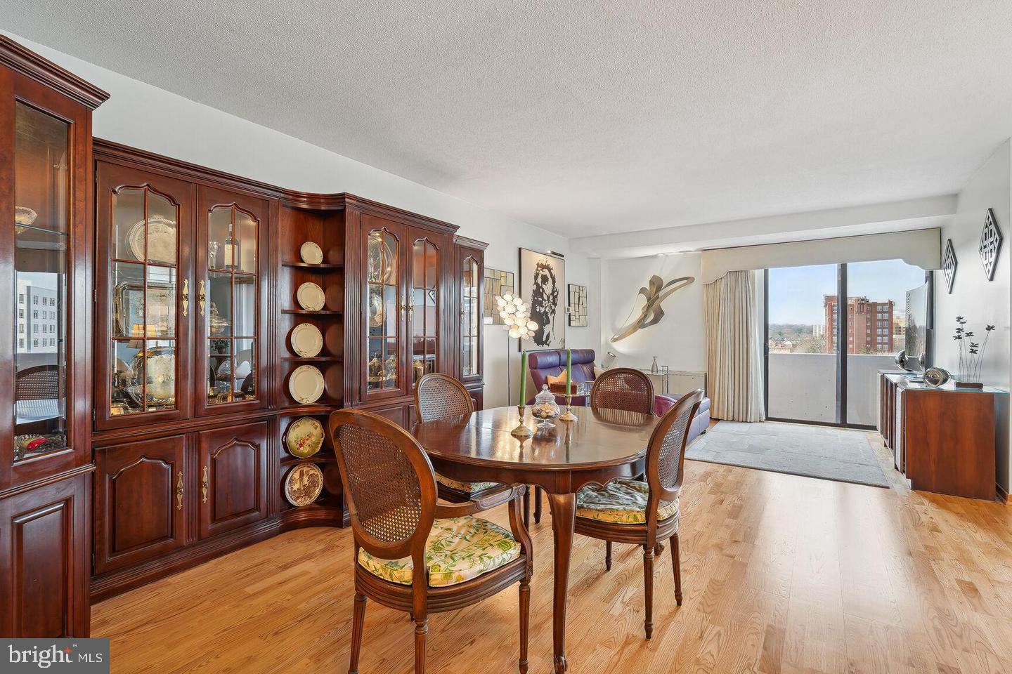 4141 North Henderson Road, Unit 611 Arlington, VA 22203 - Photo 5 of 30 a view of a dining room with furniture large windows and wooden floor